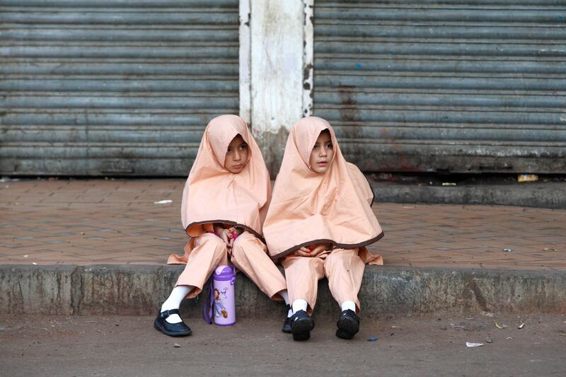 Girls in Karachi, Pakistan, wait for their school bus. Akhtar Soomro / Reuters