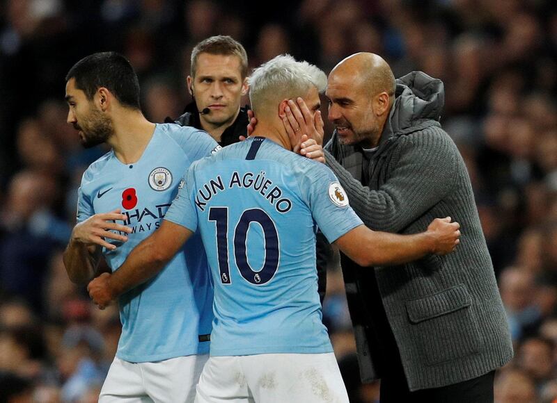 Manchester City's Sergio Aguero with manager Pep Guardiola as he is substituted. Reuters