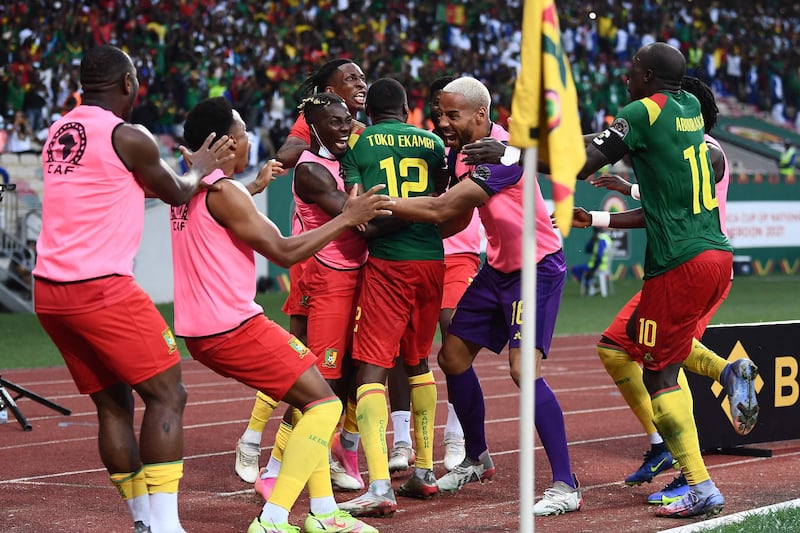 Cameroon's Karl Toko Ekambi, number 12, celebrates with teammates after scoring his team's second goal against Gambia on Saturday. AFP