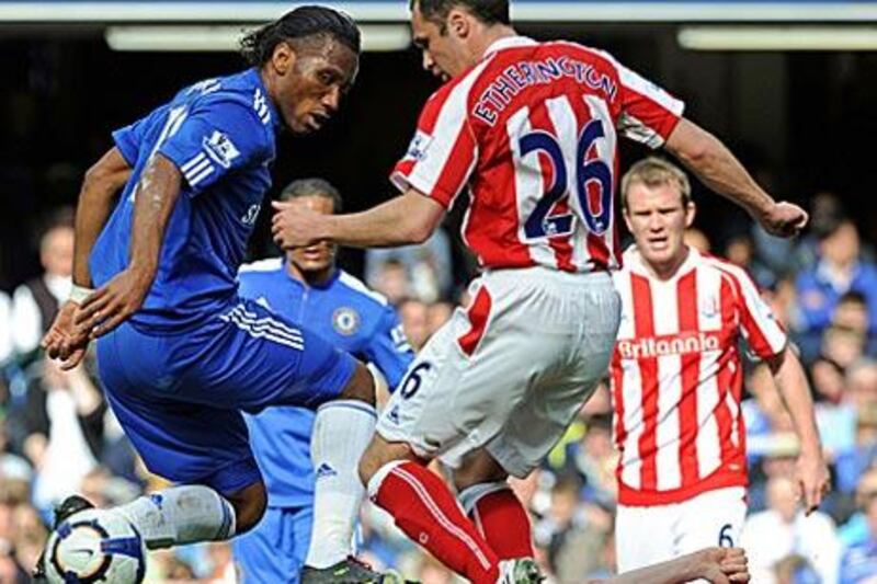 Chelsea?s Didier Drogba jumps over desperate tackles from the Stoke defence yesterday.