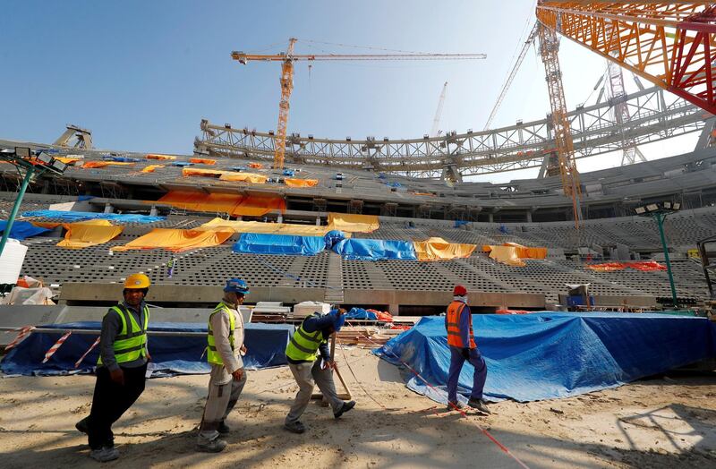 FILE PHOTO: Workers are seen inside the Lusail stadium which is under construction for the upcoming 2022 Fifa soccer World Cup during a stadium tour in Doha, Qatar, December 20, 2019.  REUTERS/Kai Pfaffenbach/File Photo