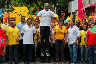 Maldives' opposition presidential candidate Ibrahim Mohamed Solih, center, jumps as he walks in a street march with supporters in Male, Maldives, Saturday, Sept. 22, 2018. Solih, the only contender in Sunday's election against incumbent President Yameen Abdul Gayoom, is backed by former President Mohamed Nasheed who is now living in exile in neighboring Sri Lanka. (AP Photo/Eranga Jayawardena)