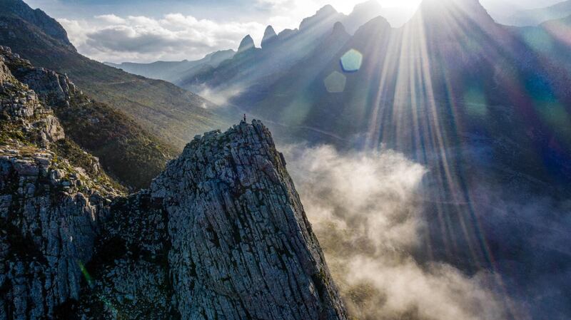 A man stands at the top of a peak on Di-Hamri mountain. The four islands and two rocky islets, home to some 50,000 people, have remained relatively untouched by the war that has devastated Yemen's mainland, with adventurous travellers showing a growing interest in visiting. AFP