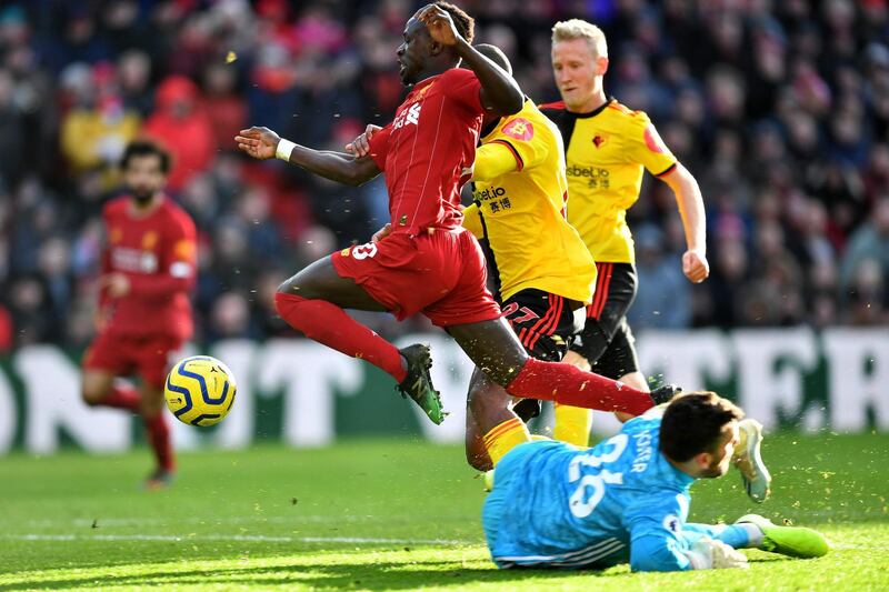 Liverpool's Senegalese striker Sadio Mane leaps over Watford goalkeeper Ben Foster. AFP