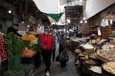 People walk at a market, amid concerns about the spread of the coronavirus disease (COVID-19), in Amman, Jordan March 23, 2021. REUTERS/Alaa Al Sukhni