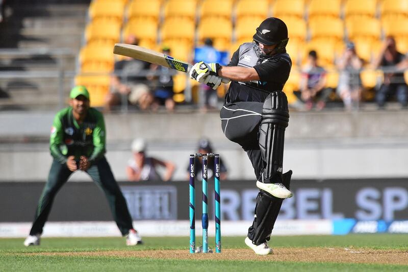 New Zealand's Glenn Phillips (R) bats watched by Pakistan's keeper Sarfraz Ahmed during the first Twenty20 international cricket match between New Zealand and Pakistan at Westpac Stadium in Wellington on January 22, 2018. (Photo by Marty MELVILLE / AFP)