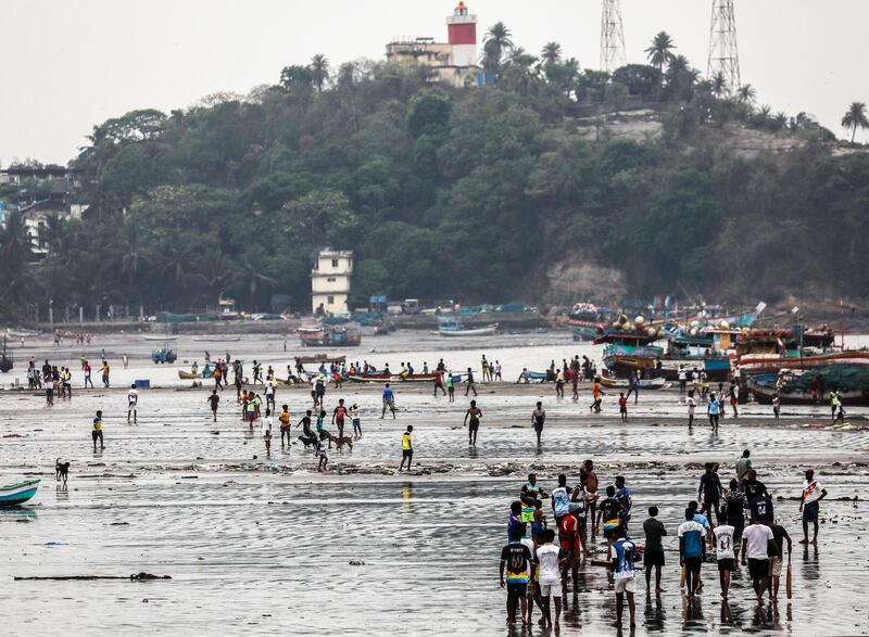 Indian fishermen gather on the shore of the Arabian Sea at the village of Uttan, near Mumbai, India. The India Meteorological Department has advised fishermen not to venture into sea along the coast of Maharashtra as a precaution against approaching tropical cyclone Nisarga.  EPA