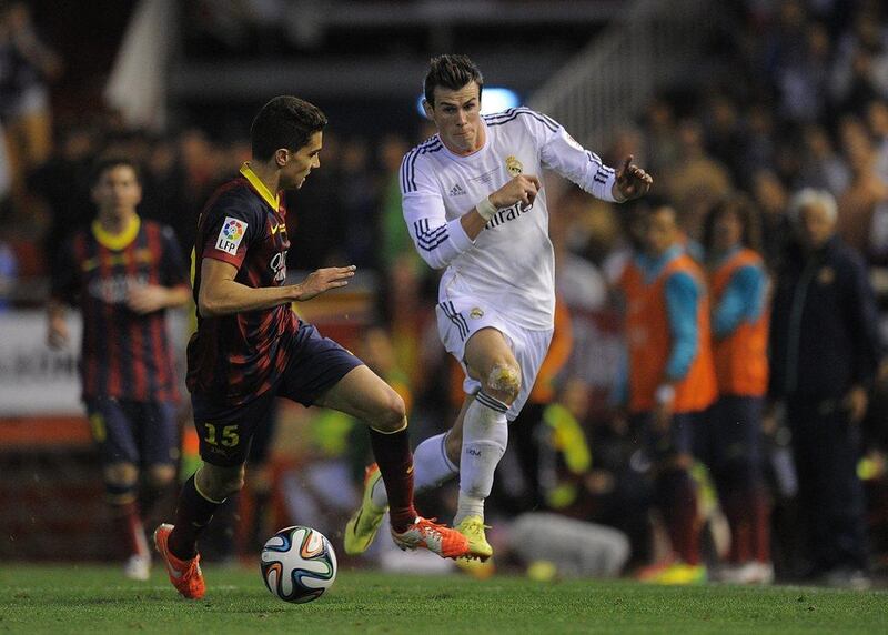 Gareth Bale, right, of Real Madrid beats Marc Bartra of Barcelona during the 2014 Copa del Rey final. Getty Images