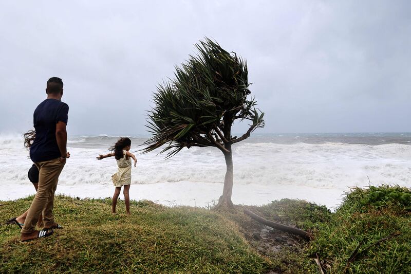 People on the French Indian Ocean island town check out the stormy weather AFP