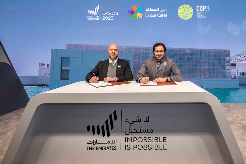 Majid Al Suwaidi, Cop28 director general and Tariq Al Gurg, chief executive and vice-chairman of Dubai Cares, announce their partnership at the UAE Pavilion, in Davos. Photo: Supplied