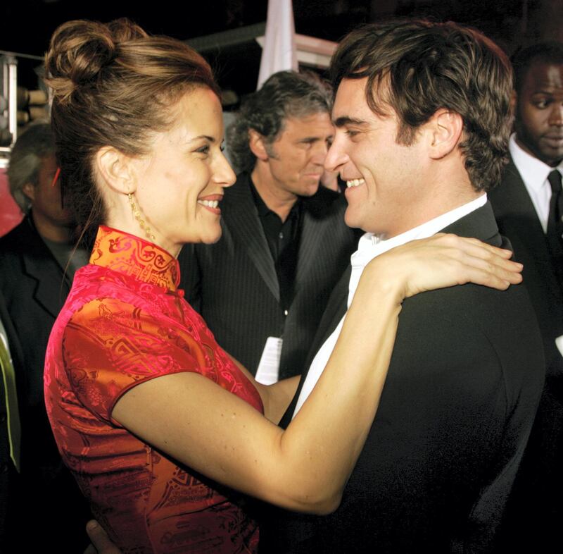 Actress Kelly Preston, wife of actor John Travolta, star of the new action drama film "Ladder 49" greets cast member Joaquin Phoenix at the film's premiere in Hollywood September 20, 2004. The film follows the lives and work of a group of fireman and opens in the United States October 1. REUTERS/Fred Prouser  FSP