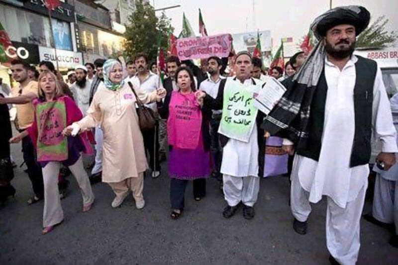 Peace activists from the US and supporters of Pakistan Tehreek-e-Insaf protest against the drone attacks in the Pakistani tribal region at Islamabad on Saturday.