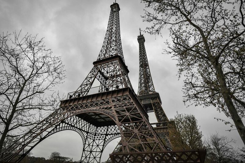 A replica, left, of the Eiffel Tower, set near the original one in Paris. AFP