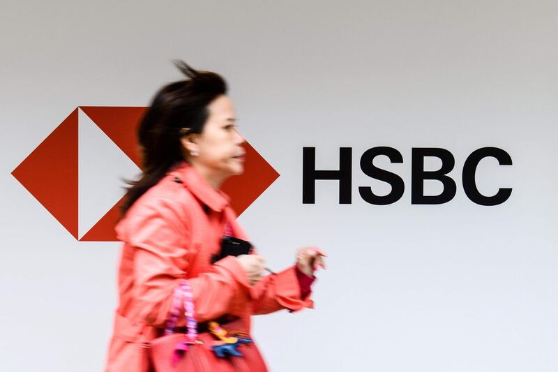 (FILES) This file photo taken on February 20, 2018 shows a commuter running past an advertisement for HSBC bank in Hong Kong.
Banking giant HSBC said on August 6, 2018 that pre-tax profit rose 4.58 percent to 10.7 billion USD in the first six months of the year and voiced "cautious optimism" despite the China-US trade row. / AFP PHOTO / ANTHONY WALLACE