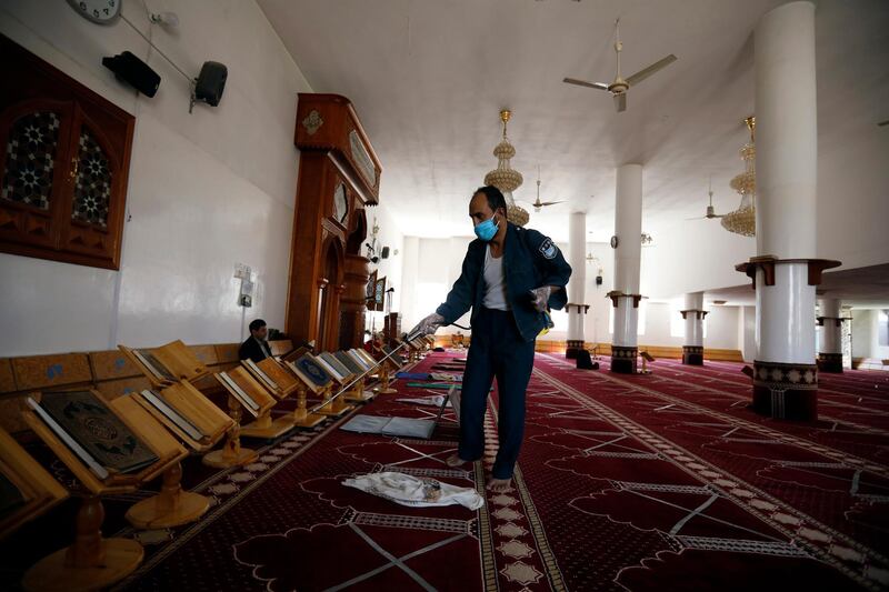 A worker sprays disinfectant inside a mosque with distancing signs ahead of Friday prayers amid the ongoing coronavirus pandemic in Sanaa, Yemen. EPA