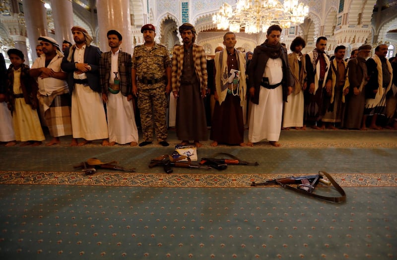 Houthi supporters leave their weapons on the floor as they attend a funeral service of Houthi fighters who were allegedly killed in the Marib offensive, at a mosque in Sana'a. EPA