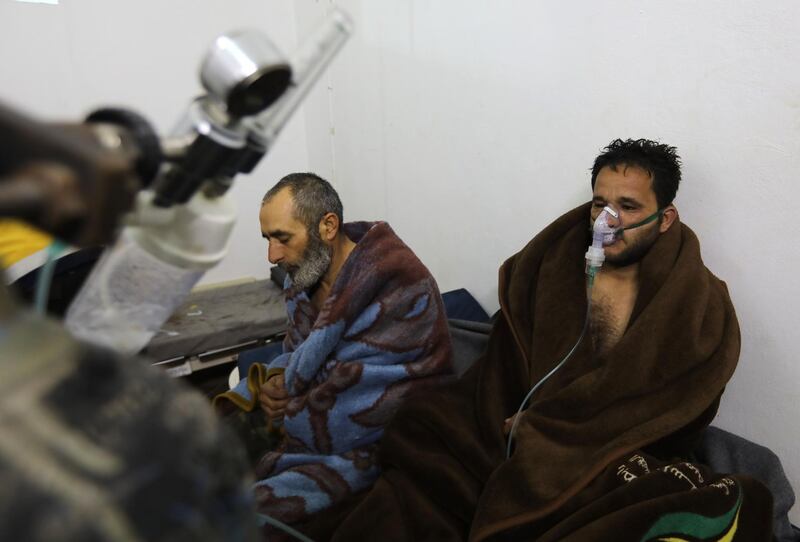 TOPSHOT - Syrians reportedly suffering from breathing difficulties following Syrian regime air strikes on the northwestern town of Saraqeb rest around a stove at a field hospital in a village on the outskirts of Saraqeb, due to the lack of hospitals in the town, on February 4, 2018.
Five people were treated for "suffocation" after Syrian regime air strikes on the northwestern town of Saraqeb, the Britain-based Syrian Observatory for Human Rights reported, adding that 10 civilians were killed in southern Idlib province. / AFP PHOTO / OMAR HAJ KADOUR