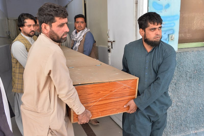 Men carry the body of a female polio vaccine worker killed by gunmen in Jalalabad, eastern Afghanistan. Photo: AFP