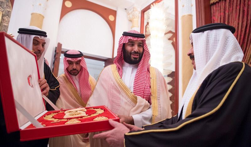 Saudi Arabia's Crown Prince Mohammed bin Salman Al Saud receives a gift from Bahraini King Hamad bin Isa Al Khalifa in Manama, Bahrain, November 26, 2018.  Bandar Algaloud/Courtesy of Saudi Royal Court/Handout via REUTERS   ATTENTION EDITORS - THIS PICTURE WAS PROVIDED BY A THIRD PARTY 