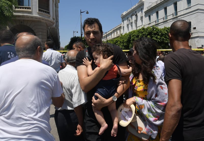 Tunisian civilians react at the site of an attack in the Tunisian capital's main avenue Habib Bourguiba.  AFP