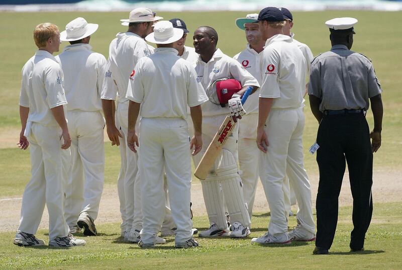ST JOHNS, ANTIGUA - APRIL 12:   Brian Lara of the West Indies is congratulated by the England team after he took his score past the previous world record, that of Matthew Hayden of Australia on 380, during day three of the 4th Test match between the West Indies and England at the Recreation Ground on April 12, 2004 in St Johns, Antigua. (Photo by Tom Shaw/Getty Images) 