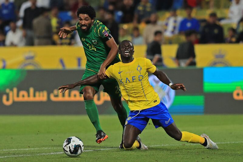 Al Nassr's new signing Sadio Mane battles with Shorta's Faisal Al Manaa. AFP