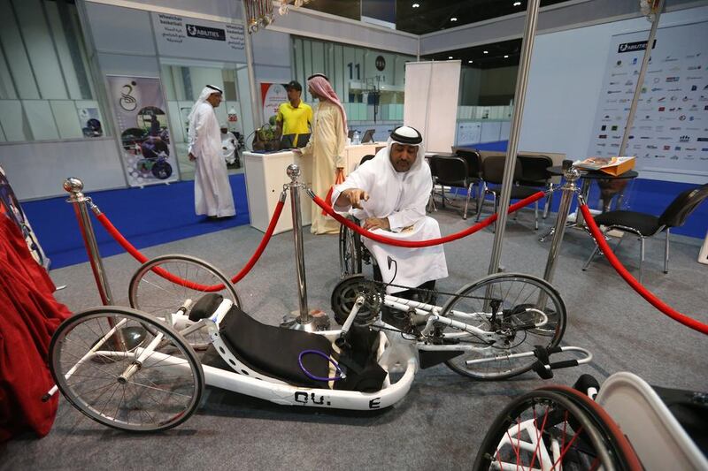 Theban Salen Al Mhairi, Secretary General of UAENPC next to a handbike.