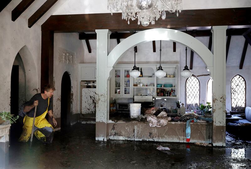 A man walks through his Montecito home that was damaged by storms. AP