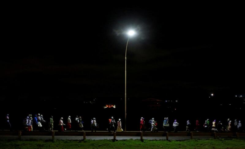 Residents walk home along a highway during the extended curfew to curb the spread of Covid-19 in the outskirts of Nairobi, Kenya. Reuters