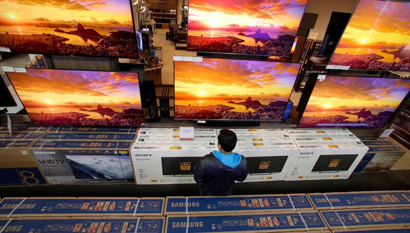 A man looks at televisions during an early Black Friday sale at a Best Buy store, in Overland Park, Kansas. AP Photo