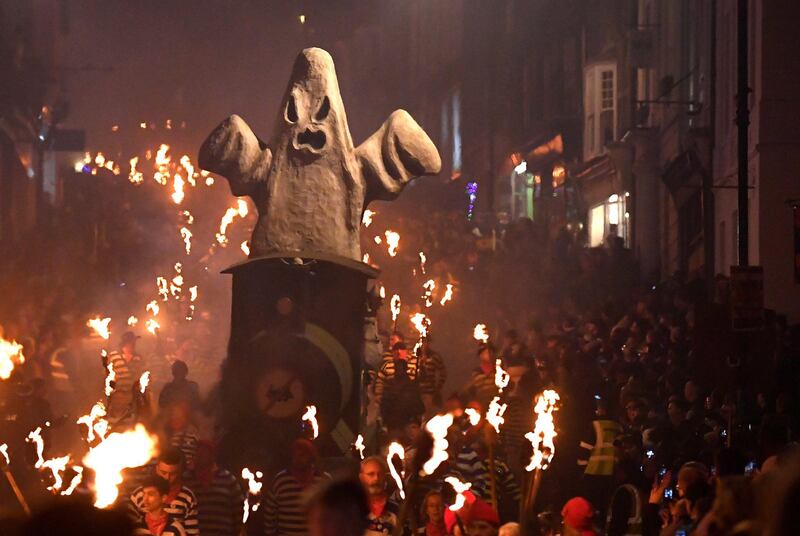 An effigy is pulled on a cart as participants parade through the town. Reuters