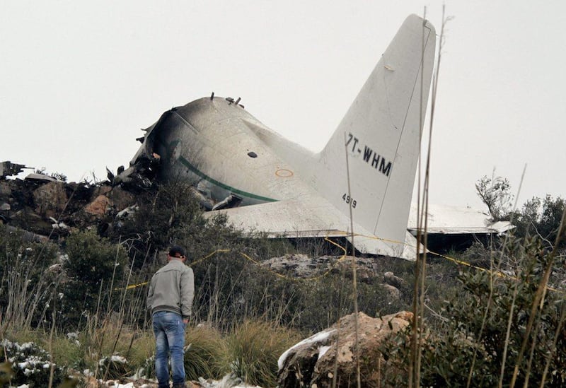 The tail section of a crashed military plane is seen in a field in the Oum El Bouaghi province, about 500 kilometers from the capital Algiers, Algeria. EPA/STR