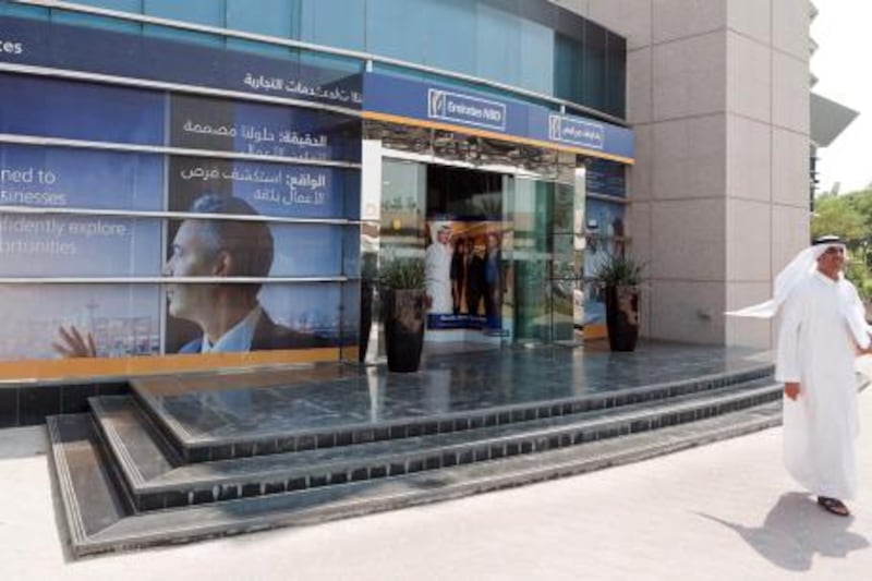 A customer exits an Emirates NBD PJSC bank branch in Dubai, United Arab Emirates, on Sunday, Oct. 16, 2011. Emirates NBD PJSC, the country's biggest lender by assets, said it will take over government-controlled Islamic lender Dubai Bank PJSC. Photographer: Duncan Chard/Bloomberg *** Local Caption ***  922446.jpg