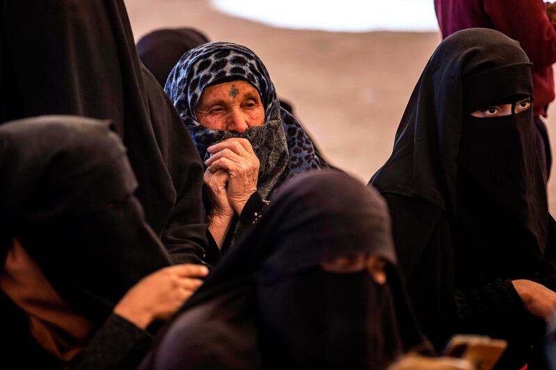 Syrian women wait to leave the Kurdish-run al-Hol camp holding relatives of alleged Islamic State (IS) group fighters, in the al-Hasakeh governorate in northeastern Syria, on November 24, 2020. A Kurdish official in charge of the region's camps, said 515 people from 120 families were returning to areas in the east of Deir Ezzor province, the first to do so after the Kurdish authorities in northeast Syria vowed to allow thousands of Syrians including the families of IS fighters out of the over-populated camp. / AFP / Delil SOULEIMAN
