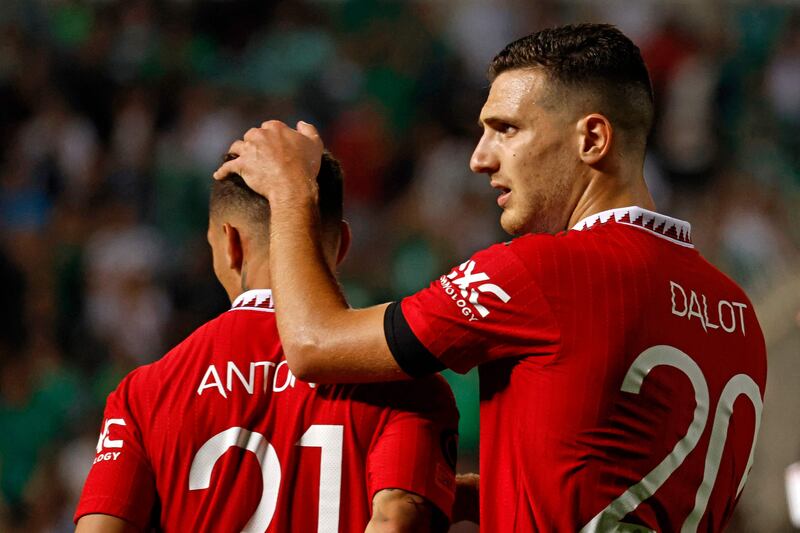 Manchester United defender Diogo Dalot, right, embraces teammate Anthony at the end f the Europa League match against Omonia Nicosia. AFP