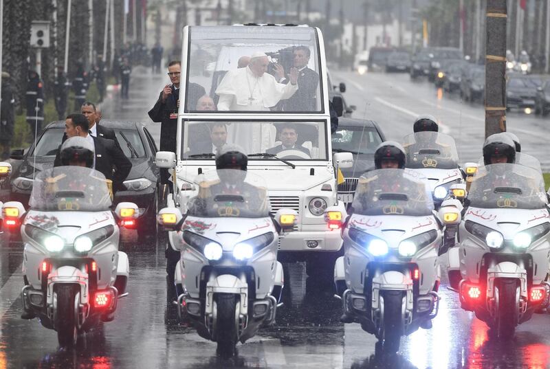 Pope Francis waves from the popemobile as he leaves the airport. AFP