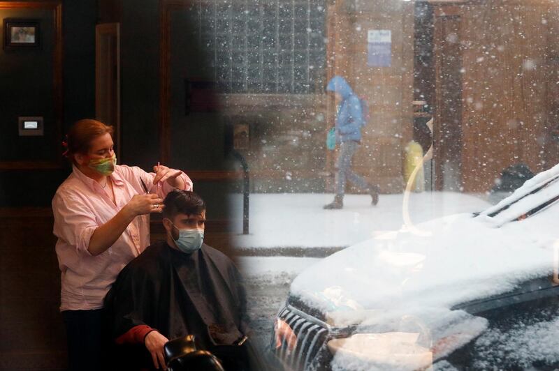 A man gets a haircut as fresh snow falls in Chicago, US. AP Photo