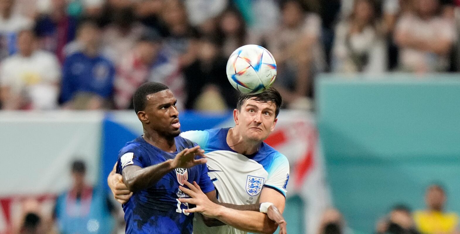 England's Harry Maguire, right, vies for the ball with Haji Wright of the United States during the World Cup group B soccer match between England and The United States, at the Al Bayt Stadium in Al Khor , Qatar, Friday, Nov.  25, 2022.  (AP Photo / Luca Bruno)