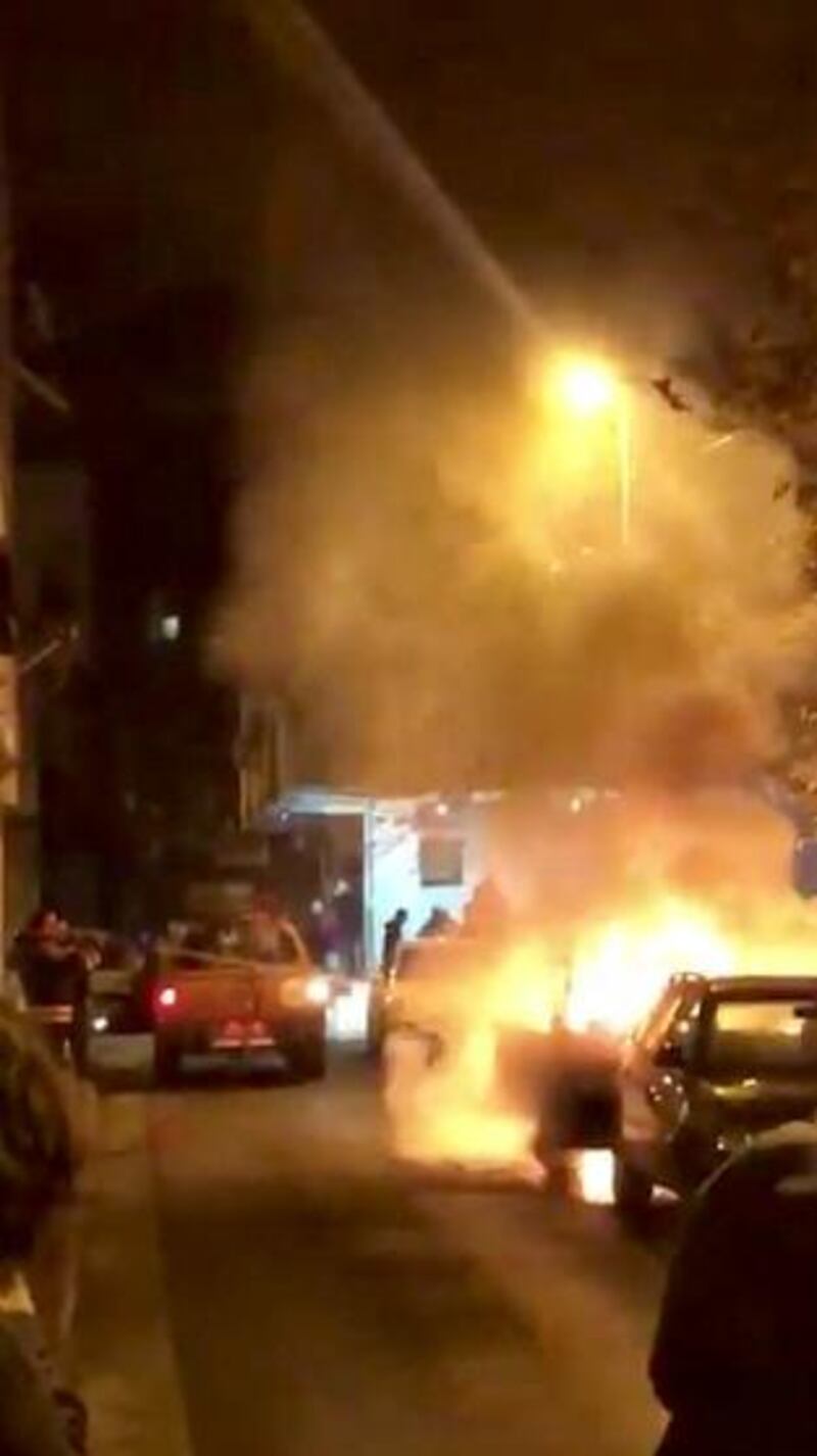 A car is seen on fire after a car alarm short-circuited following a strong earthquake in Tirana, Albania in this picture obtained from social media. REUTERS
