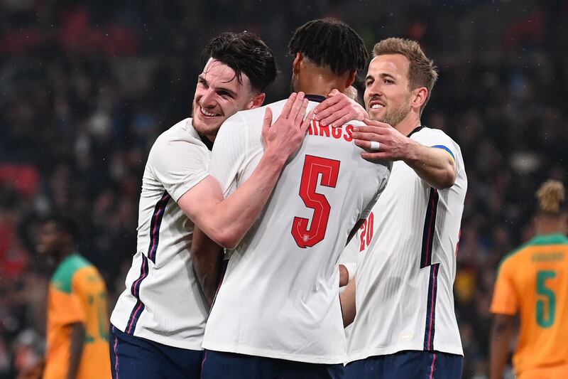 Tyrone Mings celebrates with Declan Rice and Harry Kane. AFP