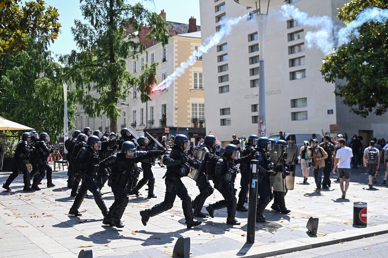 Riot police confront protesters during a demonstration against the government's pension reform plan in Nantes, France. AFP
