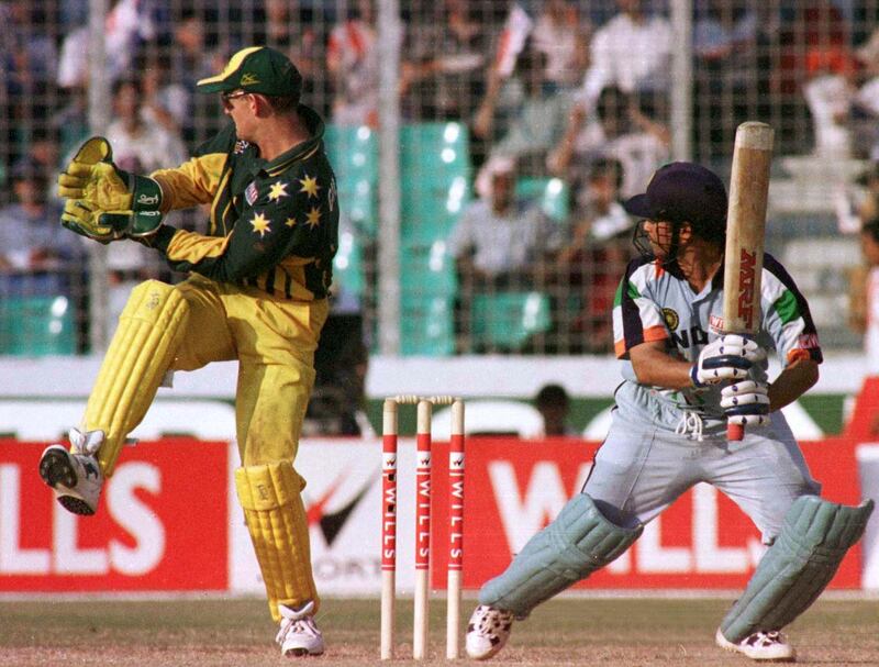 Australian wicket keeper Adam Gilchrist (L) looks back helplessly as India's Sachin Tendulkar (R) hits a boundary off Michael Kasprowicz in the quarter-final match of the Wills International Cup in Dhaka October 28. Tendulkar scored 141 before being run out. India finished their innings at 307 for eight in 50 overs.

AN/JJ/JDP