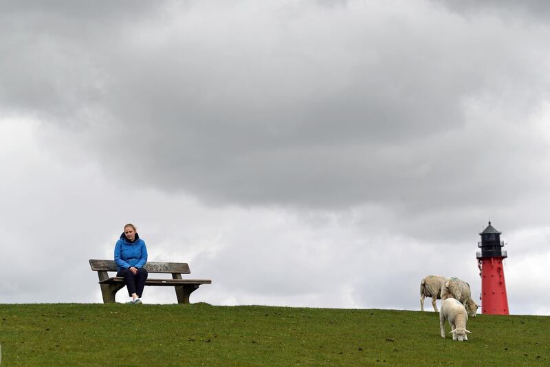 Sophie Backsen, 22, daughter of a farming family, which forced Germany by court to tighten its climate law, sits on a dyke on the North Sea island of Pellworm, Germany May 3. Reuters