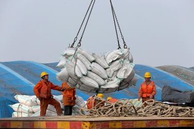 Workers at a port in Nantong in east China's Jiangsu province. China and US are engaged in 16-month long trade ward. AP