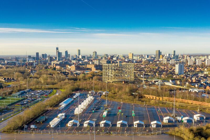 MANCHESTER, ENGLAND - JANUARY 12: An aerial drone view of the Etihad tennis centre, being used as a mass vaccination centre against Covid-19 and the drive through testing centre in the car park on January 12, 2021 in Manchester, England. The location is one of several mass vaccination centres in England to open to the public this week. The UK aims to vaccinate 15 million people by mid-February. (Photo by Christopher Furlong/Getty Images)