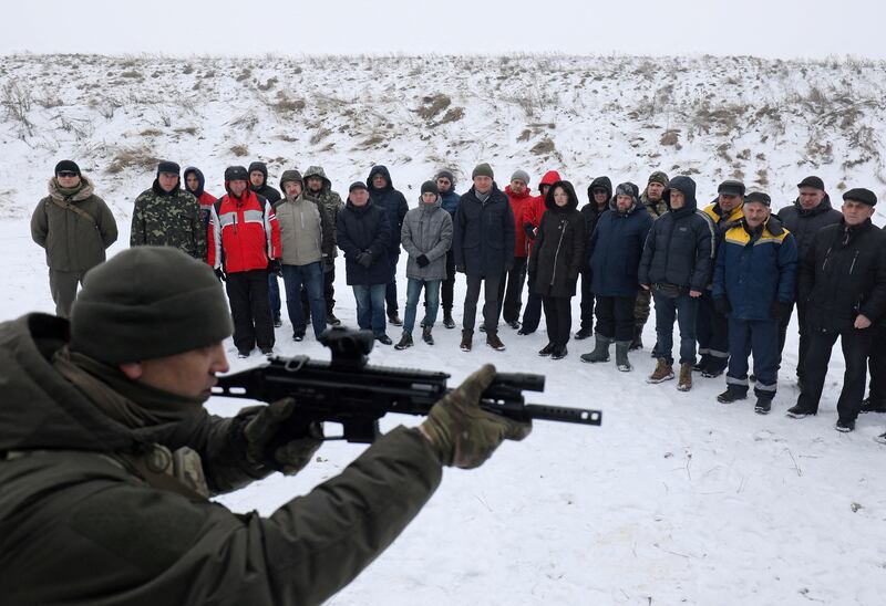 Employees of essential city industries and services attend a military training session outside Lviv, Ukraine. Reuters