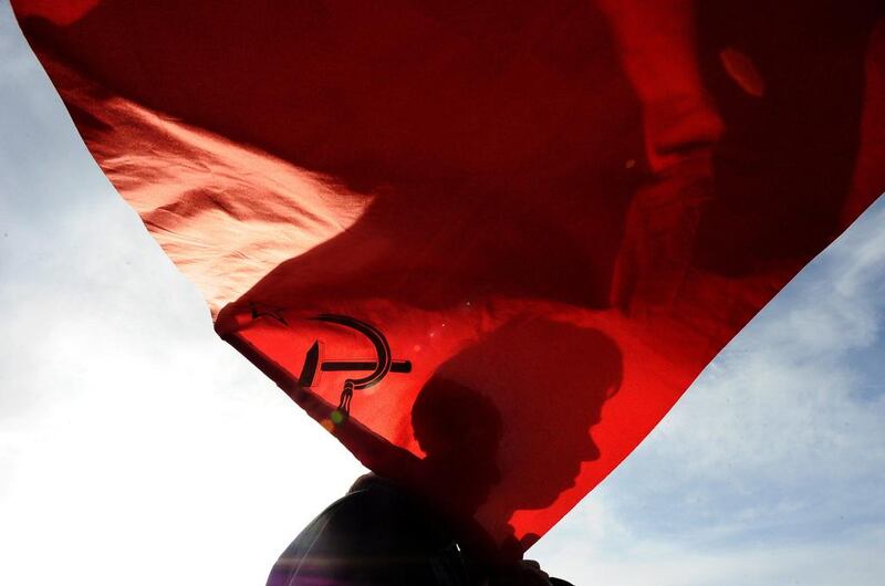 The silhouette of a mans face is seen on a Soviet Union flag during a rally n St. Petersburg to show support for pro-Russian authorities of Crimea. Olga Maltseva / AFP Photo