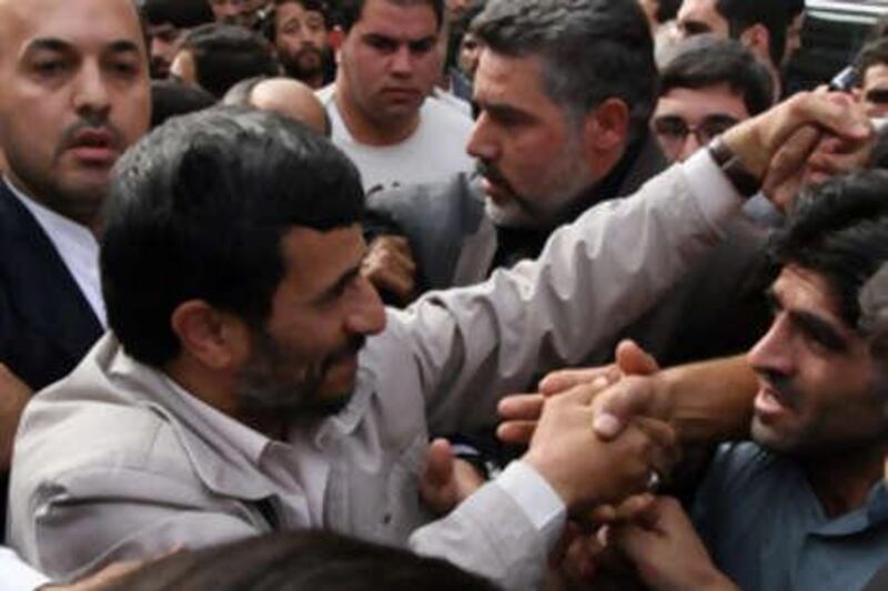 Iranian President Mahmoud Ahmadinejad, left, greets his supporters during a religious ceremony marking the death of the Shiite Saint Jaafar Sadeq in Tehran on Saturday Oct, 25, 2008. The world's 120 million Shiites venerate the  sixth imam, or spiritual successor to the Prophet Muhammad, of the Shi'ite branch of Islam and the last to be recognized as imam by all the Shi'ite sects. Theologically, he advocated a limited predestination and proclaimed that Hadith (traditional sayings of the Prophet), if contrary to the Qur'an, should be rejected. (AP photo/Hasan Sarbakhshian)  *** Local Caption ***  XHS103_IRAN_AHMADINEJAD.jpg