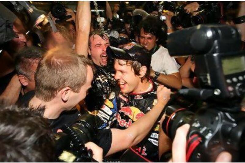 Sebastian Vettel, of Red Bull-Renault, is mobbed after his victory in the capital yesterday.