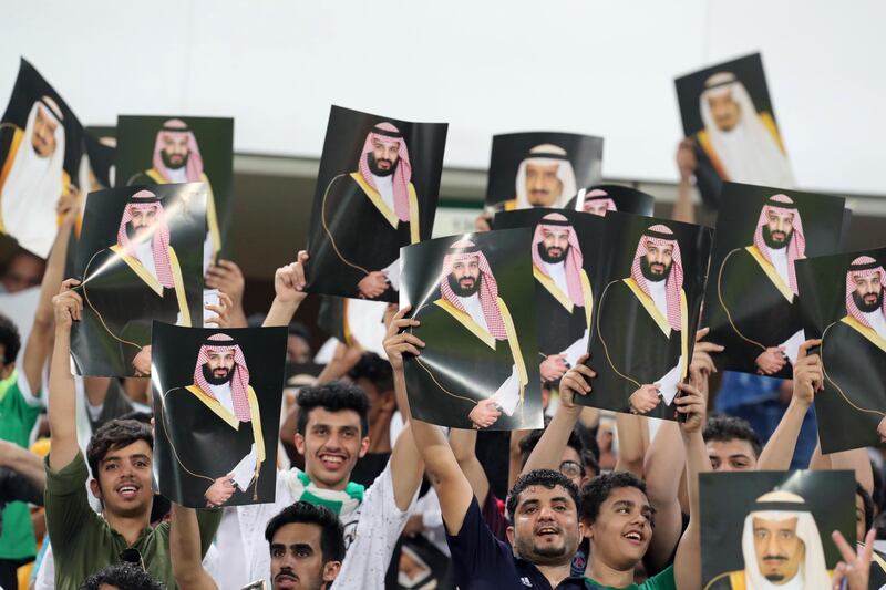 
                  Saudi Arabia fans cheer as they hold up pictures of Saudi King Salman and Saudi Crown Prince and Minister of Defense Mohammed bin Salman during the 2018 World Cup group B qualifying soccer match between Saudi Arabia and Japan in Jiddah, Saudi Arabia, Tuesday, Sept. 5, 2017. Saudi Arabia won 1-0. (AP Photo)
               